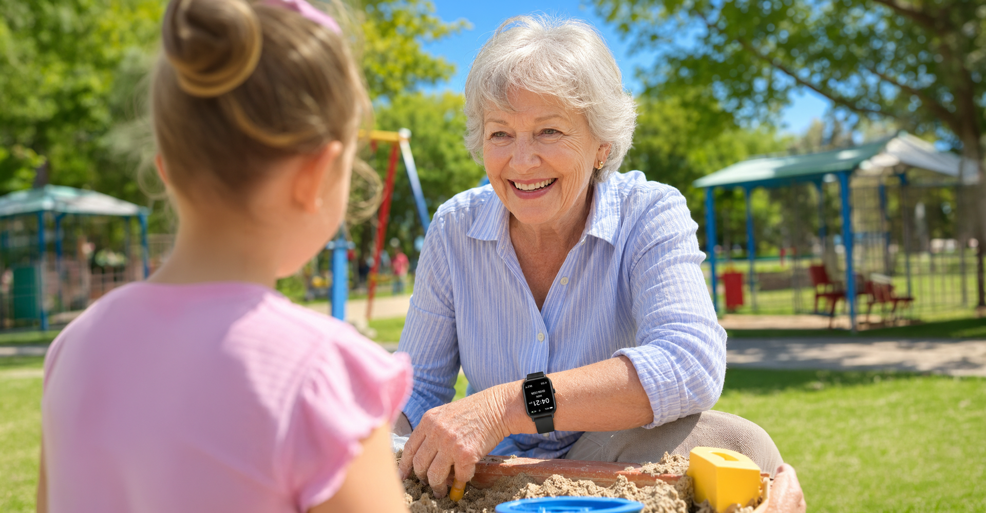 Grandmother wearing the VitalALERT™ watch at the playground with her grandchild